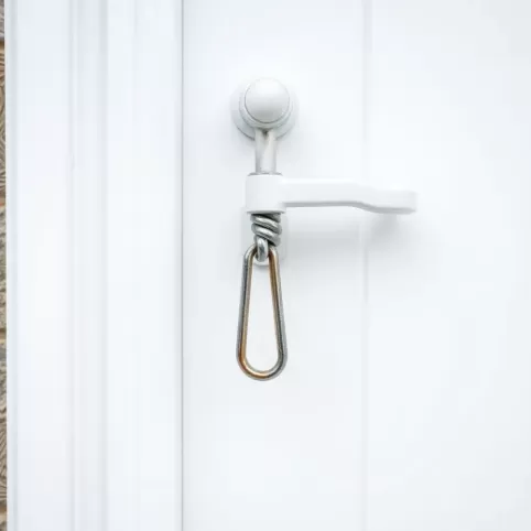 Przekręcona klamka w drzwiach balkonowych